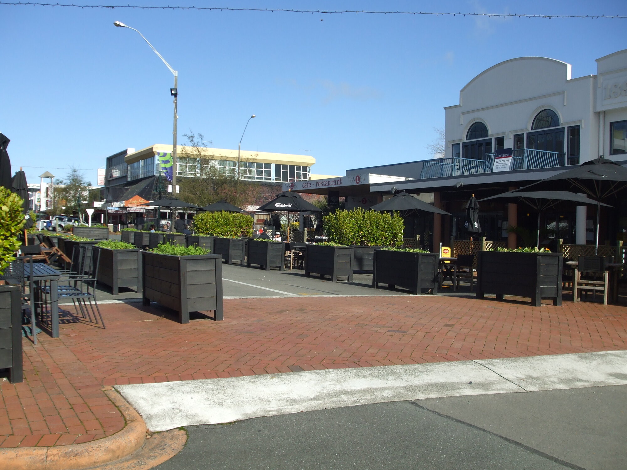Photograph of Eat Streat, showing outdoor seating with planter boxes, 2012 