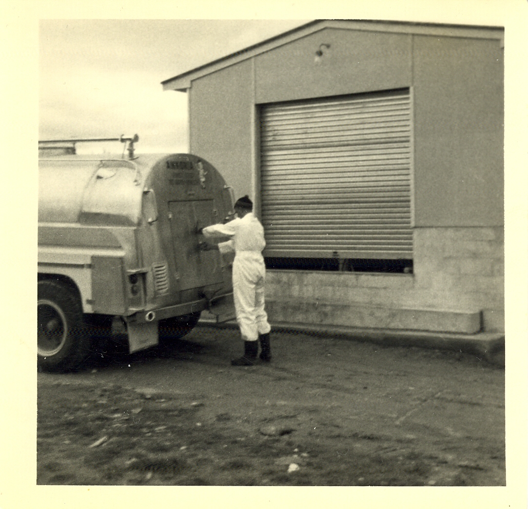 Photograph of Mr Cam Neil, locks truck to go the next farm, 1968