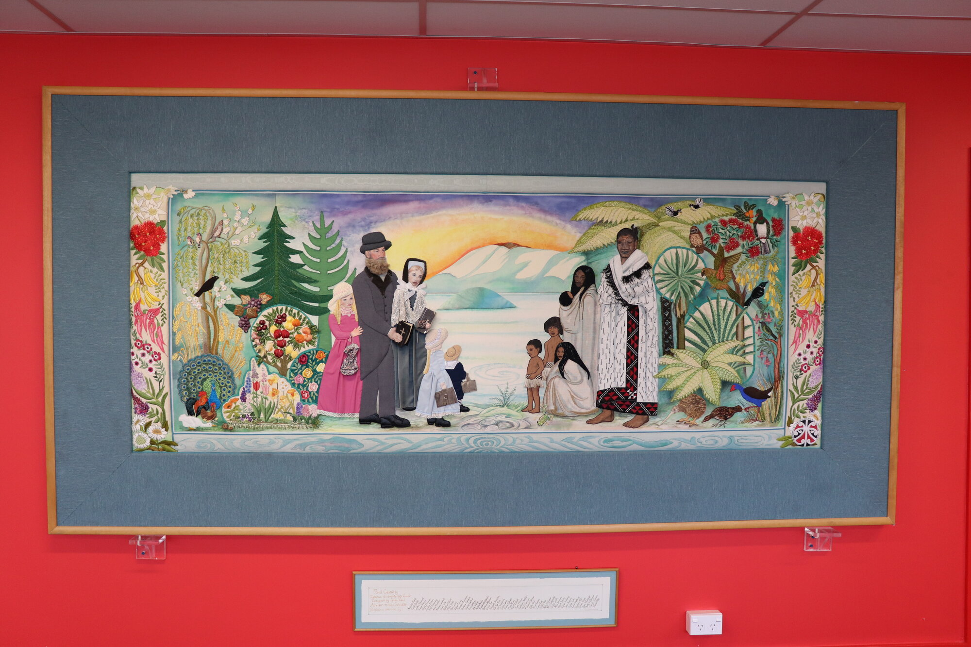 Photograph of an embroidered wall hanging after installation on the second floor of Rotorua Library