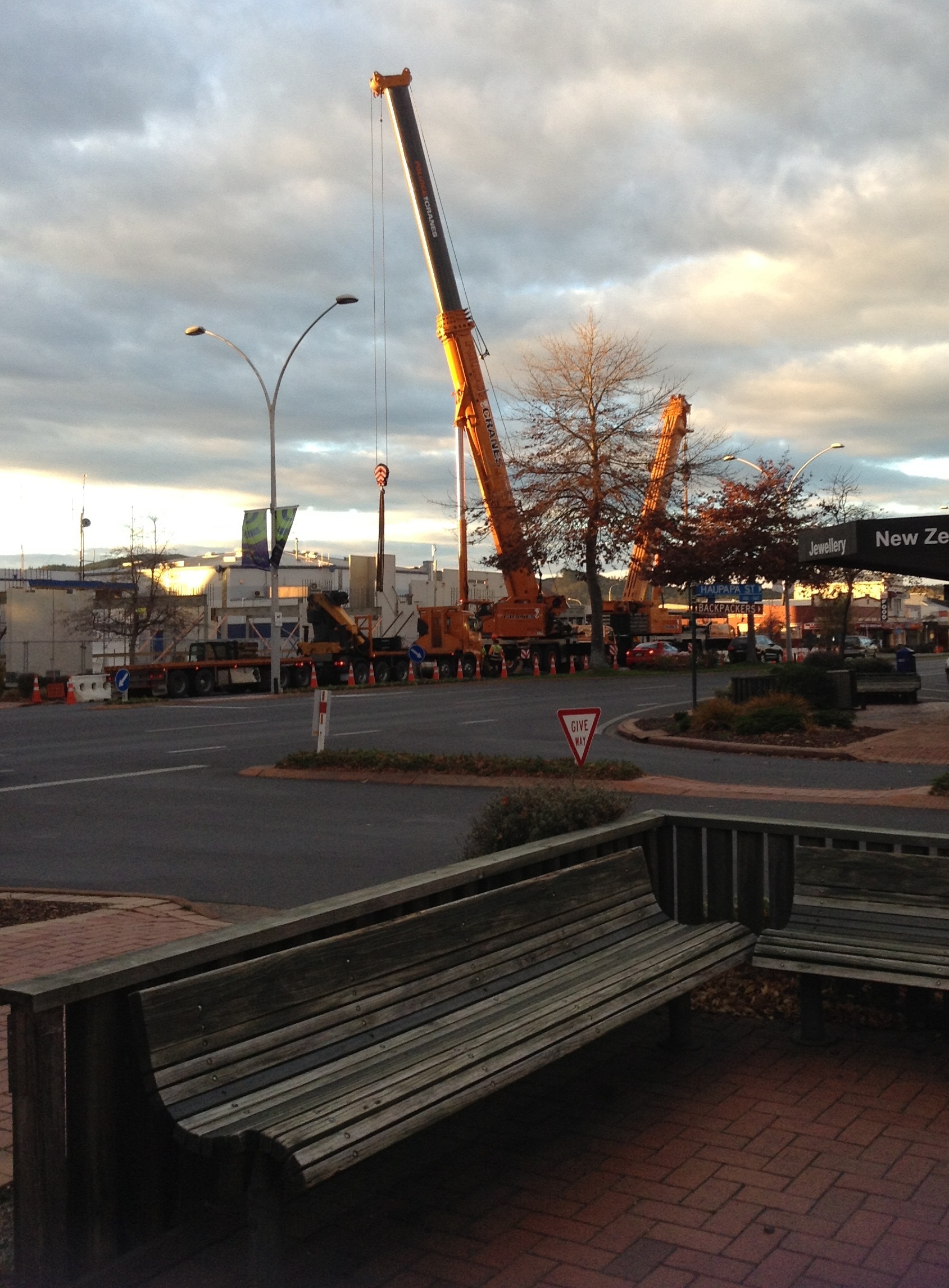 Photograph showing two large cranes lowering concrete slabs for the Rotorua Police Station