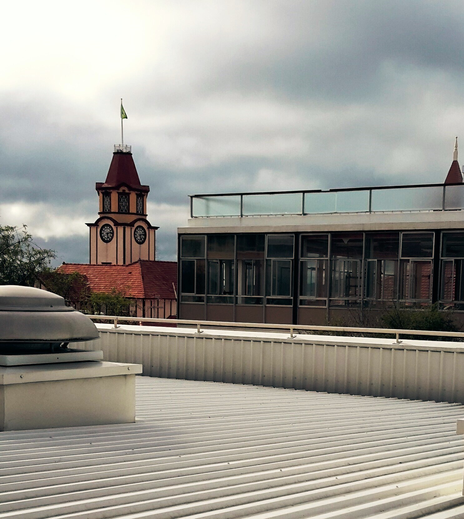 Photograph showing the start of the demolition of Community House with the old Post Office in view