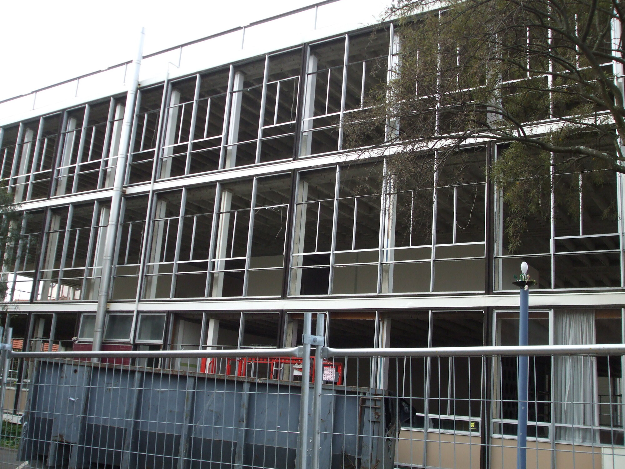 Photograph showing the last bit of the demolition of Community House, the old window frames
