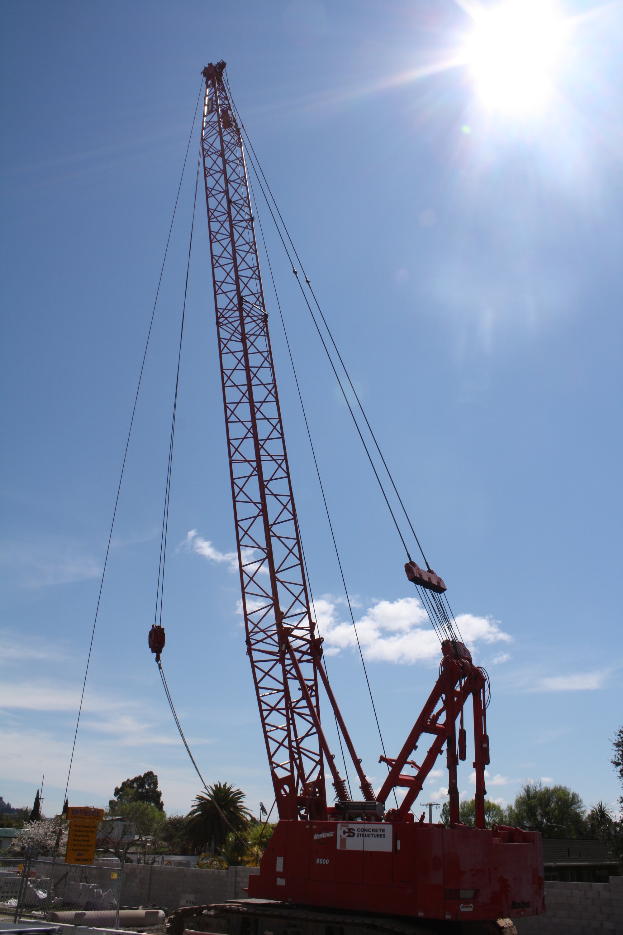 Photograph of a crane moving heavy concrete pipes, 2012