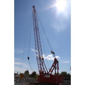 Photograph of a crane moving heavy concrete pipes, 2012