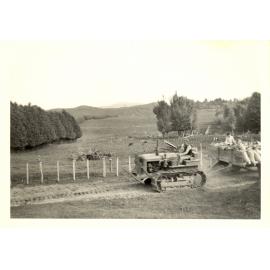 Photograph of farm bulldozer with sacks of seed,  ca.1959