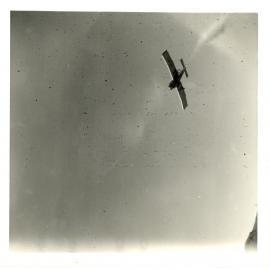 Photograph of the aerial topdressing plane overhead, ca.1959