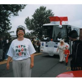 Photograph of staff member Janet ahead of the new mobile library in the Rotorua Christmas Parade