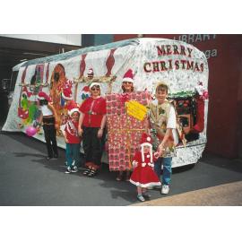 Photograph of  the Rotorua Public Library Rotorua Christmas Parade float with library staff posing