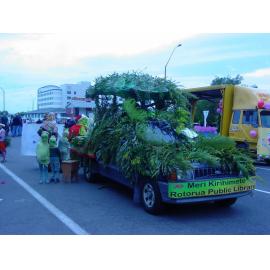 Photograph of the library float for the Rotorua Christmas Parade which features mascot Fletcher the Tuatara and some huhu grubs