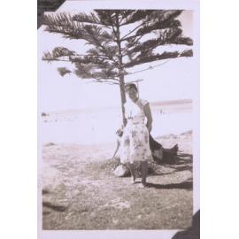 Black and white photograph of a woman at the beach