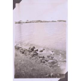 Black and white photograph of a coastal seascape (perhaps Mount Maunganui)