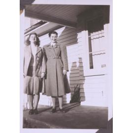 Black and white photograph of "Eunice Jolley" standing on a porch with an unidentified woman