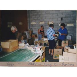 Photograph of Volunteers sorting donations for the Book Fair at a garage in White Street