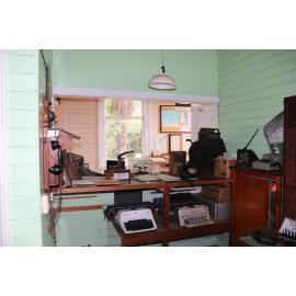 Photograph of the old Whakarewarewa Post Office, showing the service desk with typewriters