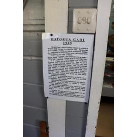 Photograph of the old Rotorua Gaol House 1905-1965, showing a poster with description and history