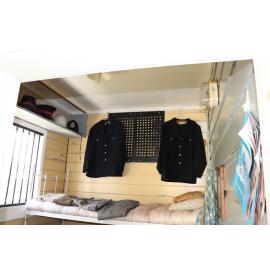 Photograph of the inside of the Rotorua Gaol House 1905-1965, showing the jailer's uniform