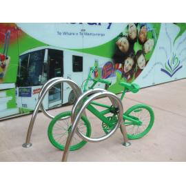 Photograph of old painted bicycle parked outside the library in Haupapa Street