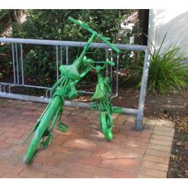 Photograph of old painted bicycle parked outside the library in Haupapa Street