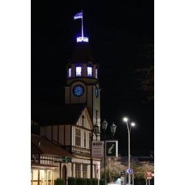 Photograph of the old Post Office clock lit up for Blue September
