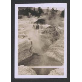 Photograph showing man and woman standing looking over mud pool, ca. 1900-1910