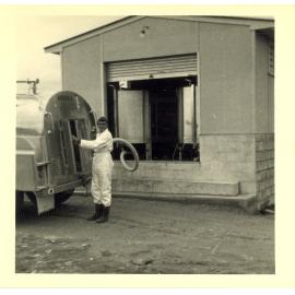 Photograph of Mr Cam Neil pumping to a tanker, 1968