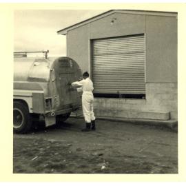 Photograph of Mr Cam Neil, locks truck to go the next farm, 1968