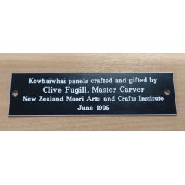 Photograph of the kōwhaiwhai panel's plaque at Rotorua Library