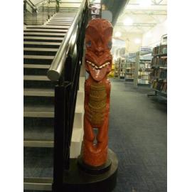 Photograph of a tekoteko installed at the base of Rotorua Library's mezzanine stairs