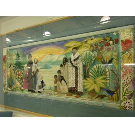 Photograph of an embroidered wall-hanging after the installation of a perspex frame for preservation