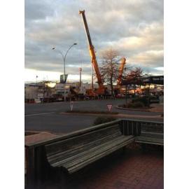 Photograph showing two large cranes lowering concrete slabs for the Rotorua Police Station