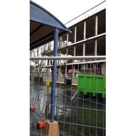 Photograph showing the start of the demolition of Community House with windows frames removed